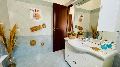 a bathroom with a sink and a mirror at La casa di Carmela e Francesco b&b in Massa