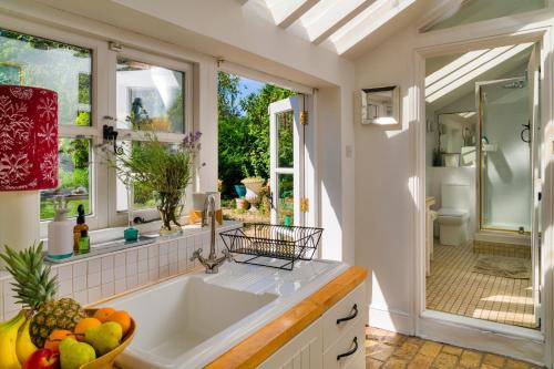 a kitchen with a sink and a window at Finest Retreats - Lavender Cottage in Methwold