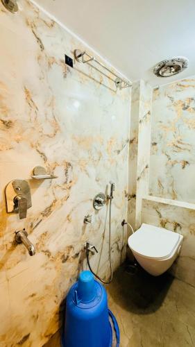 a bathroom with a white toilet and a sink at Hotel Gurukripa Palace in Maheshwar