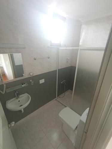 a bathroom with a toilet and a sink at Sunset Otel in Şile