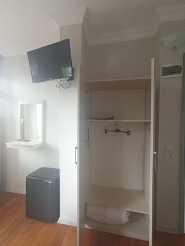 a bathroom with a toilet and a tv on the wall at Sunset Otel in Şile