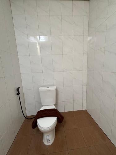 a bathroom with a toilet with a brown towel on it at บ้านศรีสุธรรม3 Baansrisutham 3 in Don Sak