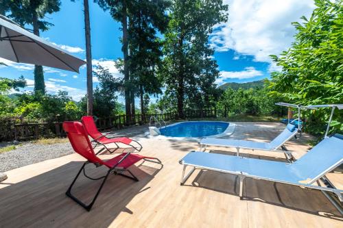 a deck with two chairs and a swimming pool at 349 - Bosco Selvaggio con piscina, Palestra, Sport & Wellness - PARCHEGGIO GRATUITO INCLUSO in Reppia