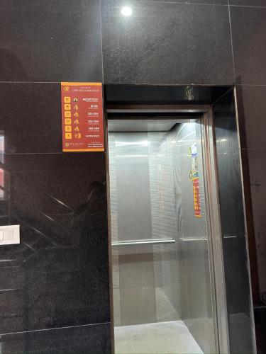 a glass door of a building with a sign on it at Chris Bed and Breakfast by Hostmandu in Jawlakhel