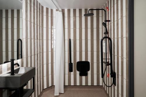 a bathroom with a shower and a sink at Four Points Flex by Sheraton London Euston in London