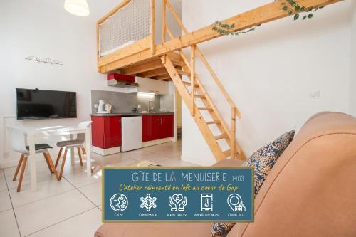 a loft bed in a living room with a kitchen at Gîte de La Menuiserie in Gap