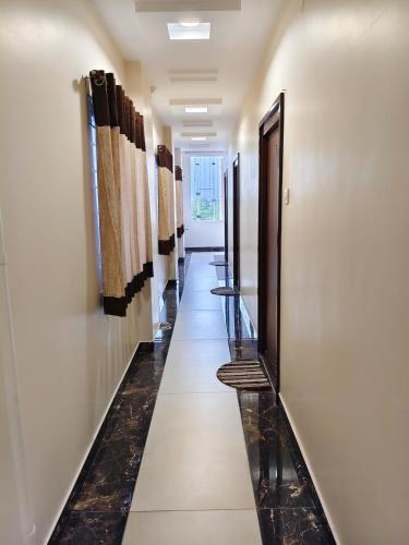 a hallway with a row of stalls in a building at Hotel KK Grand in Guntūr