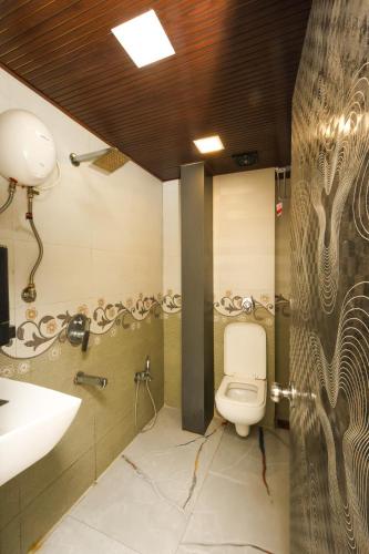 a bathroom with a toilet and a sink at Hotel Taj Palace - Near Mumbai Airport in Mumbai