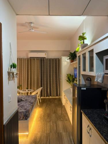 a small apartment with a kitchen and a living room at GRiK STAY in Greater Noida