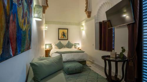 a bedroom with a bed and a chair in a room at Dar Lalzohra in Rabat