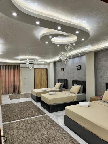 a room with two beds and a room with at Gem View Grand Boutique in Cairo