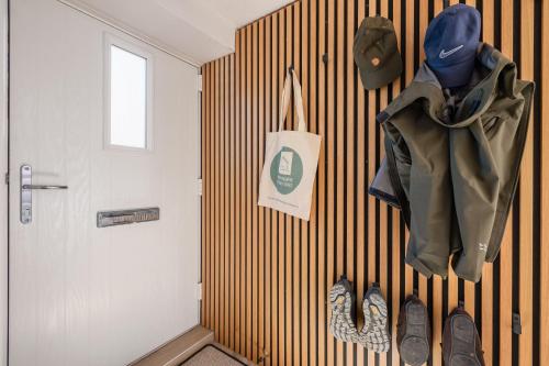 a hallway with a wall with coats and shoes on it at Eighteen Pottergate in Helmsley