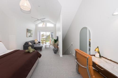 a bedroom with a bed and a couch at Breakwall Retreat in Manning Point