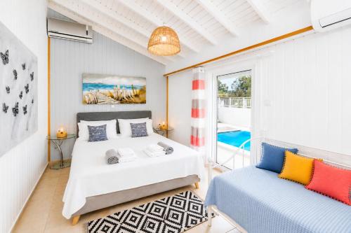 a bedroom with two beds and a balcony at Beach House Cavo Kiotari in Gennadi