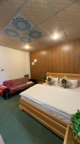 a bedroom with two beds and a ceiling at Multiple Hotels in Malam Jabba Swat in Malam Jabba