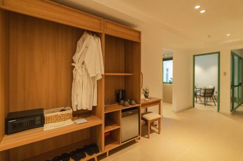 a room with a cabinet with a robe on it at dei Balconi Dalat in Ấp Ða Lợi