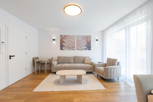 a living room with a couch and a table at Rezidence Sadová Zlín in Zlín