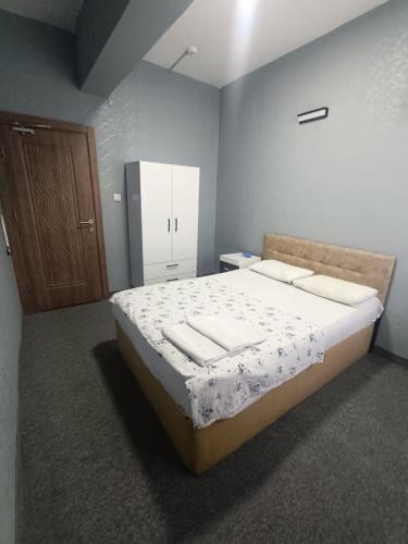 a bedroom with a bed and a wooden door at Sunrise Hotel in Antalya