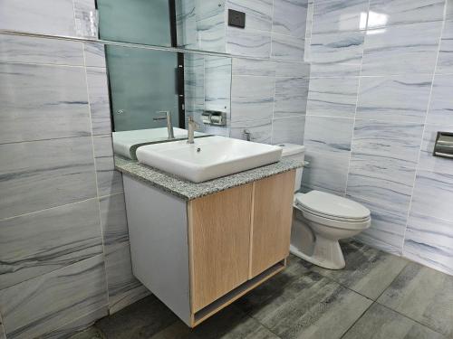 a bathroom with a sink and a toilet at Lala Inn in Gilgil