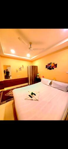 a bedroom with a large white bed in a room at Galaxy Stellar Suites in kolkata