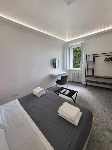 a bedroom with a bed with two towels on it at Mansio Pegaso in Tivoli
