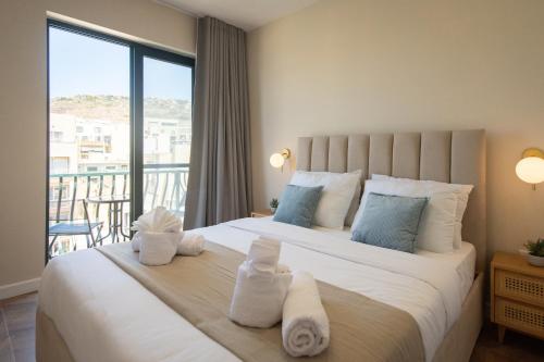 a bedroom with a large bed with towels on it at Electra Residence - Central Duplex Penthouse in Marsalforn