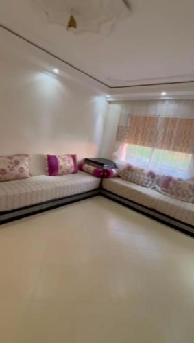 a room with two couches and a table in a room at naderi in Tangier
