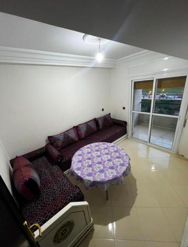 a living room with a couch and a table at naderi in Tangier