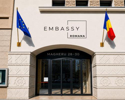 two flags flying in front of a building at Embassy Romana in Bucharest