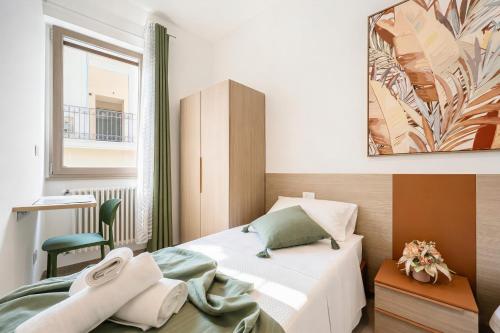 a small bedroom with a bed and a window at Domus dell'Angelo in Monte SantʼAngelo