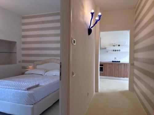 a bedroom with a bed and a room with a kitchen at franciacorta iseo lake house in Clusane sul Lago