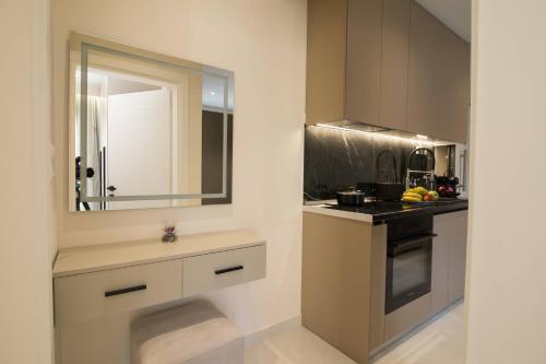 a small kitchen with a sink and a mirror at Glamour Residences 5-6 by CorfuEscapes in Análipsis