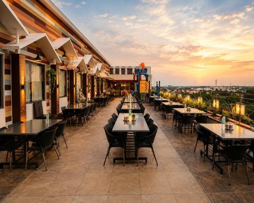 a restaurant with tables and chairs on a building at Hotel Rockfort View by Park Elanza in Tiruchirappalli