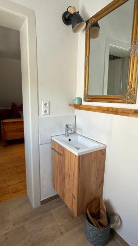 a bathroom with a sink and a mirror at Ferienwohnung Eule in Kastellaun