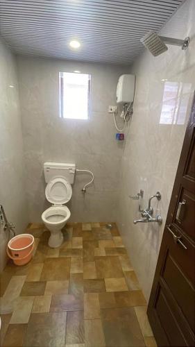 a bathroom with a toilet and a window at The Byke Retreat - Laxmi Resort - Pan India Pure Veg Hotel Chain in Matheran