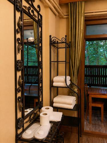 a bathroom with a mirror and a shelf with towels at Motto Polonezköy in Beykoz