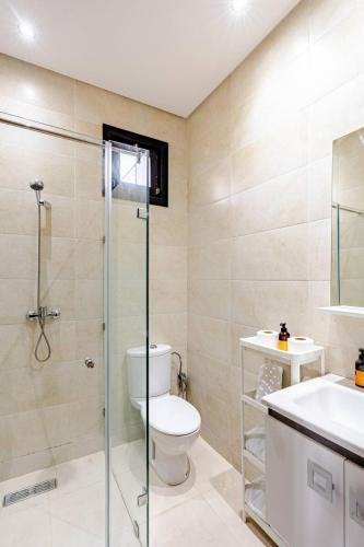 a bathroom with a toilet and a sink and a shower at MVIEW Villas in Marrakesh