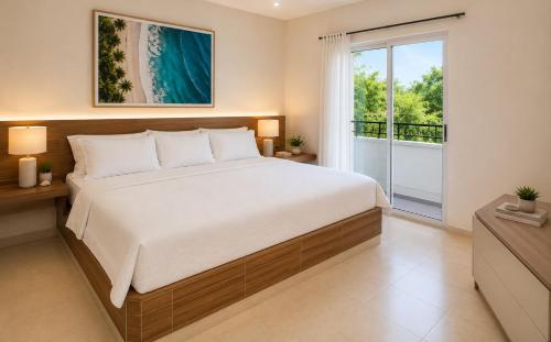 a bedroom with a large bed and a balcony at La Costa Playa El Agua Hotel in El Agua