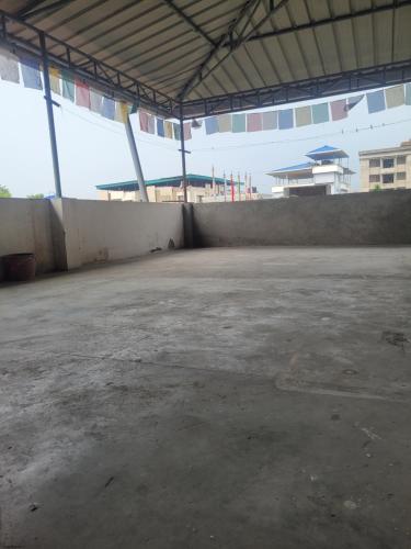 an empty parking lot in a large building at Aama Ghar Siliguri in Siliguri