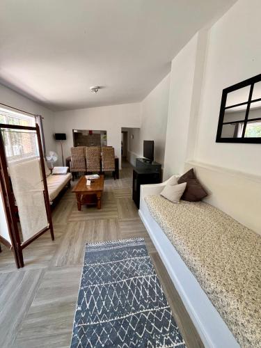 a room with two beds and a living room with a couch at Off-grid Guest House in the Algarve in Portimão