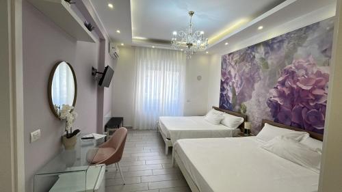 a hotel room with two beds and a mirror at Maison De luxe in Pompei