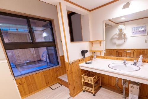 a bathroom with a sink and a large window at 灯ノ環tomonowa in Mitsuwa