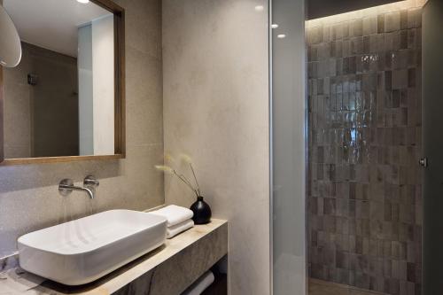 a bathroom with a sink and a shower at Atlantica Callisto in Ayia Napa