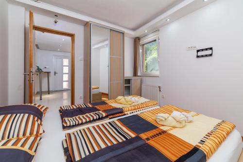 two beds in a room with two chairs at Villa Adry 2 in Bribir