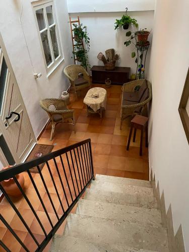 a hallway with chairs and a table and a staircase at Donna Teresa in Castelbuono