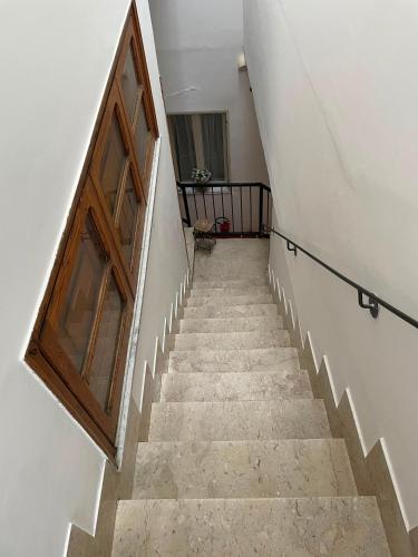 a stairway with a wooden door and a stair case at Donna Teresa in Castelbuono