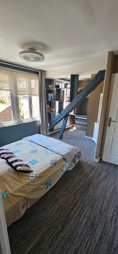 a bedroom with a bed and a staircase at Le petit Rouen in Rouen
