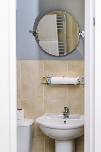 a bathroom with a sink and a mirror at Red Lion Inn and Motel in York