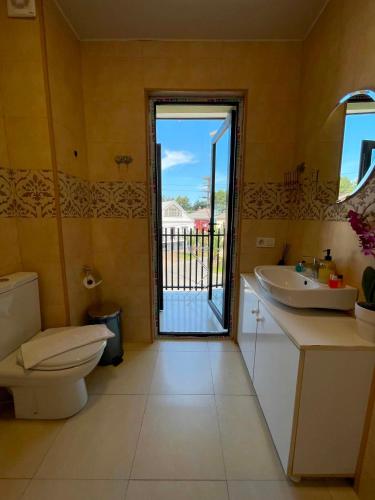 a bathroom with a toilet and a sink and a window at New House Kobuleti 2 in Kobuleti