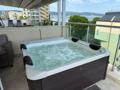a hot tub sitting on top of a balcony at YS Residence in Sunny Beach